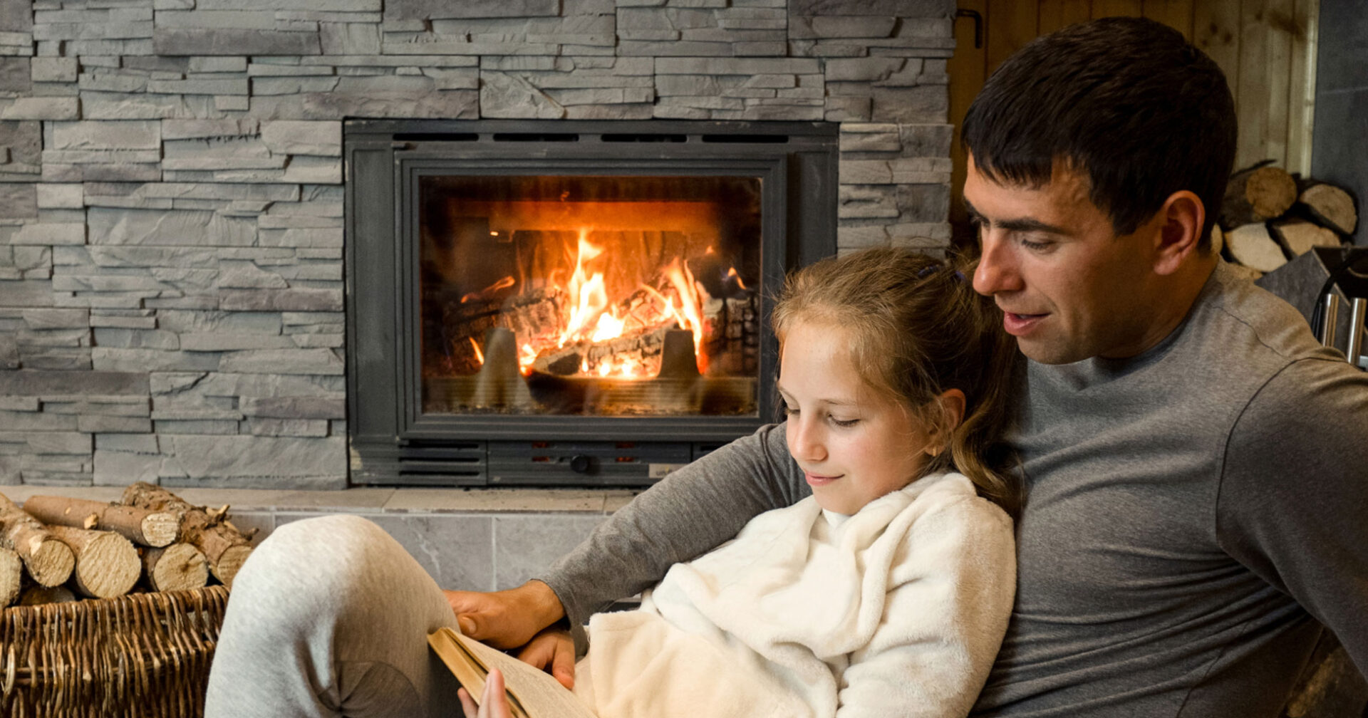 father and daughter in front of a fireplace