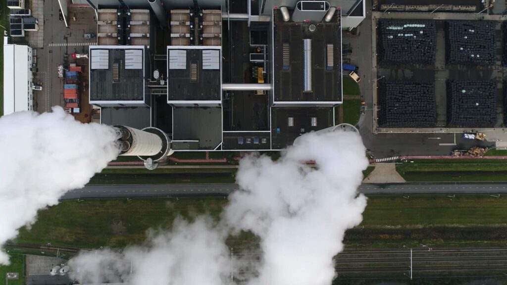 Coal power plant with chimney stacks, seen from above.