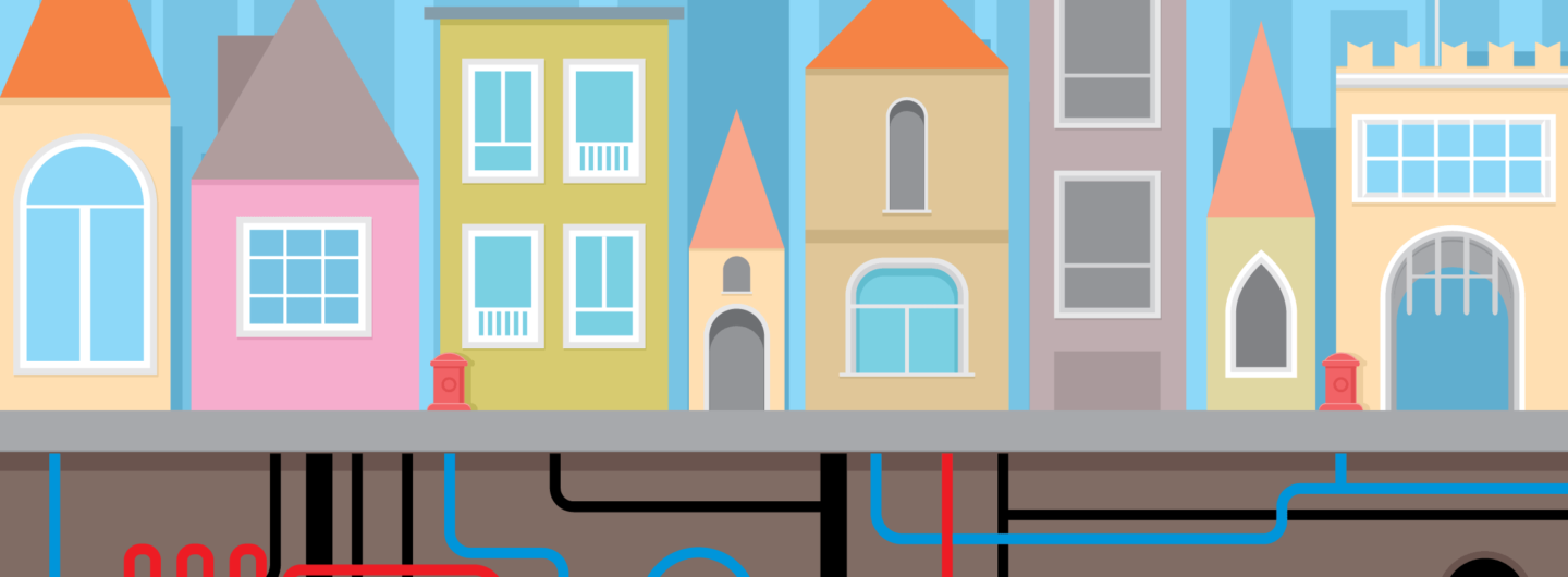 Illustrasjon av en by med fjernvarmerør under bakken