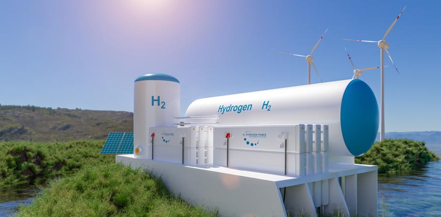 Hydrogen tanks with wind turbines in the background.