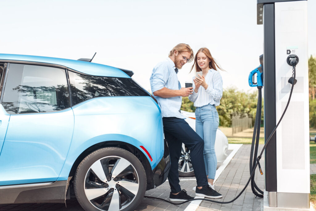 couple charging an electric car