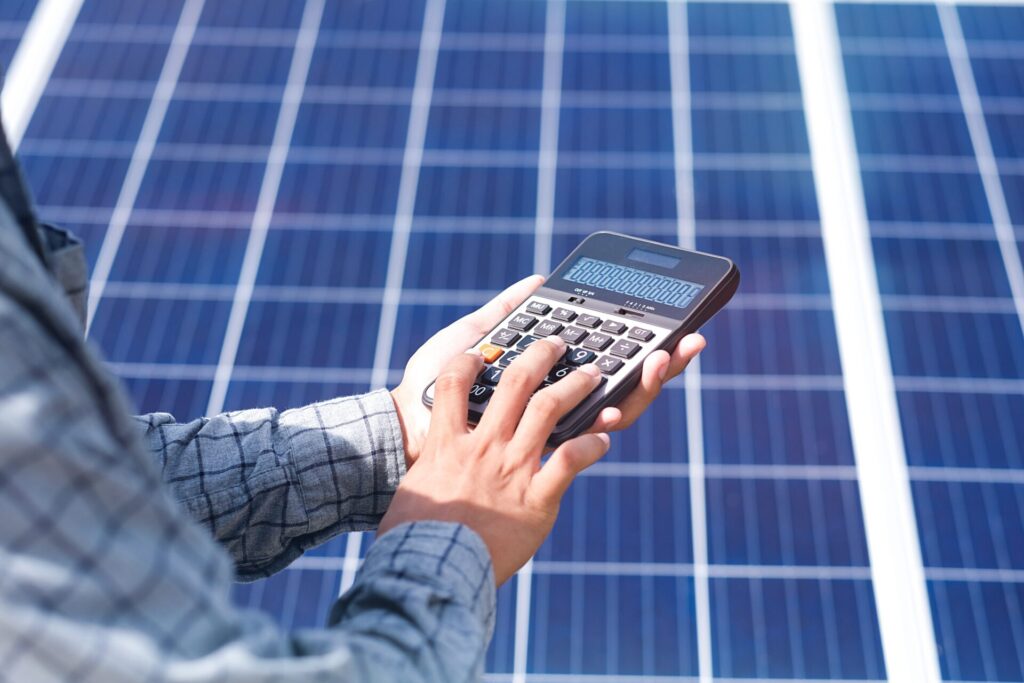 Hand,Holding,Calculator,With,Solar,Panel