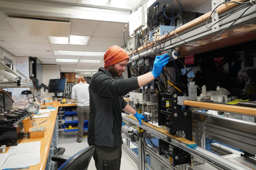 Peter Betlem measuring P-wave velocities of the recovered sequences at discrete intervals.