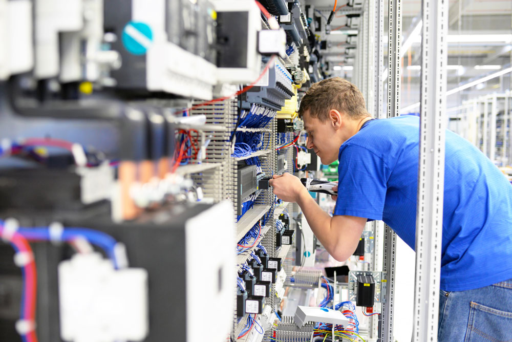 person with cables in a factory