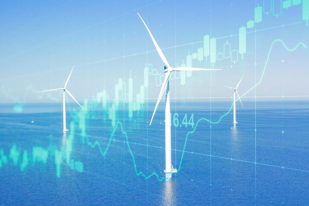 Composite image showing a photo of an offshore wind farm with an market graph overlay.