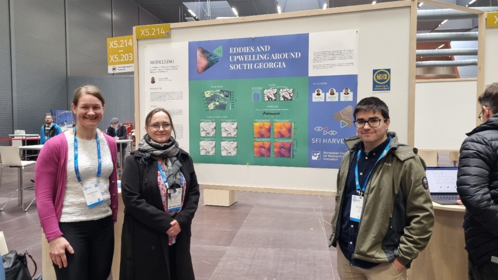 Group of researchers in front of a poster.