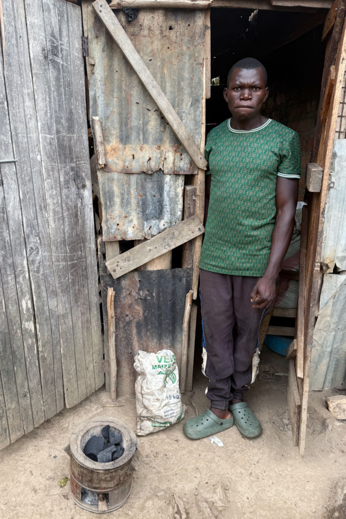 A man and a traditional charcoal stove for cooking